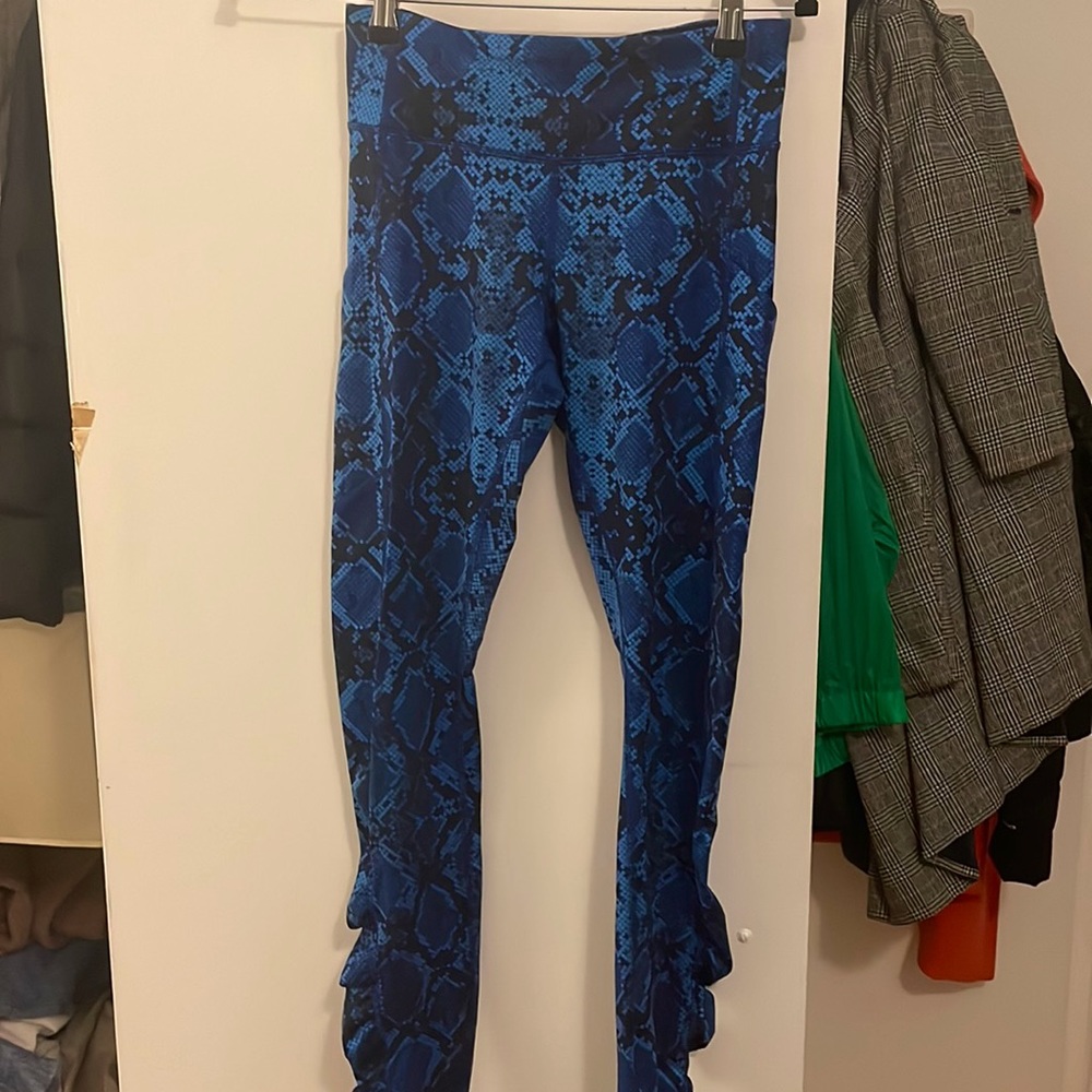 Blue snake print Lululemon leggings with ruching details at ankles